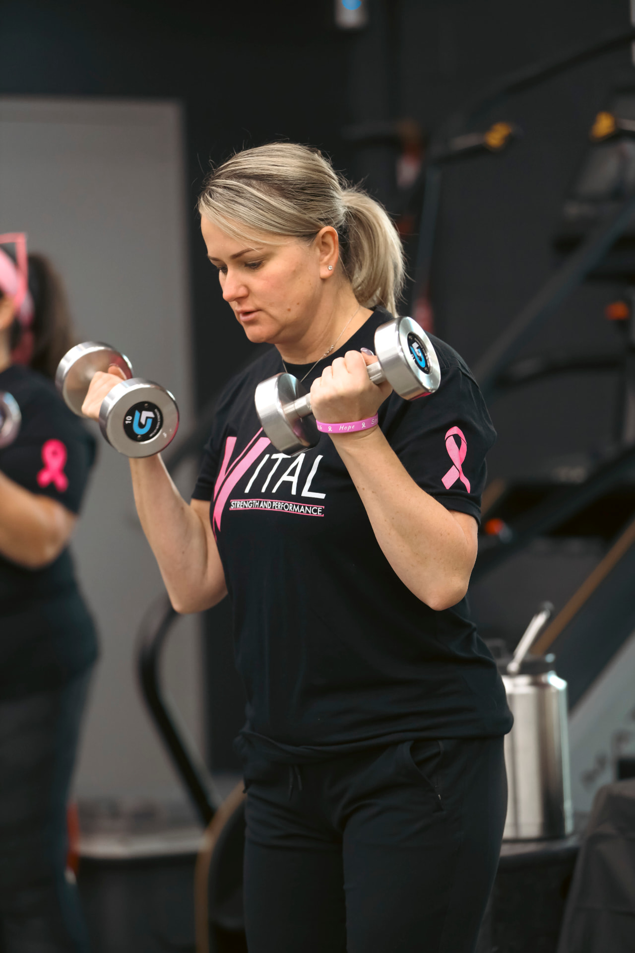 A Vital member strength training with dumbbells in the Orange, Connecticut gym
