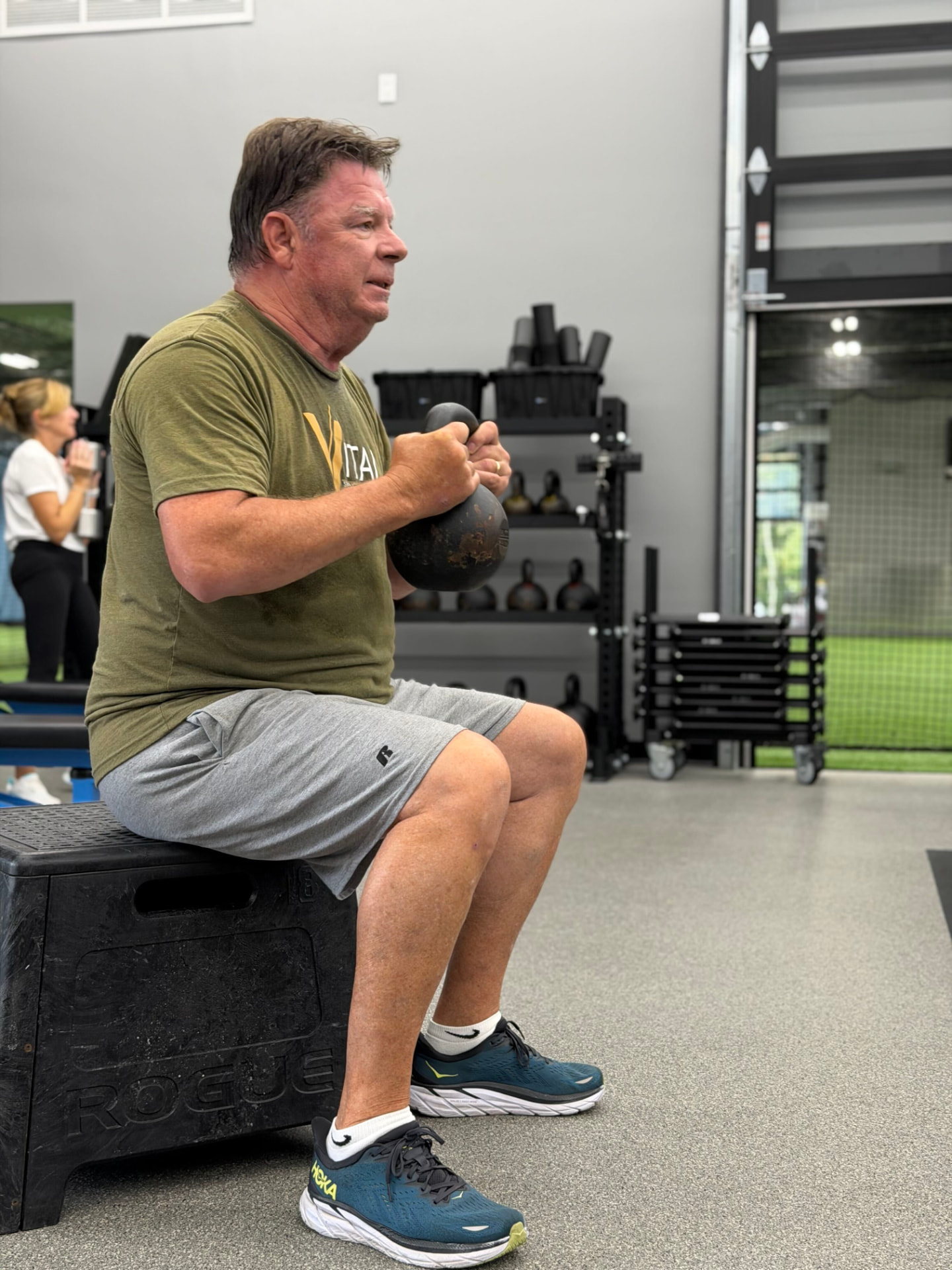 A Vital member training with a kettlebell in the gym